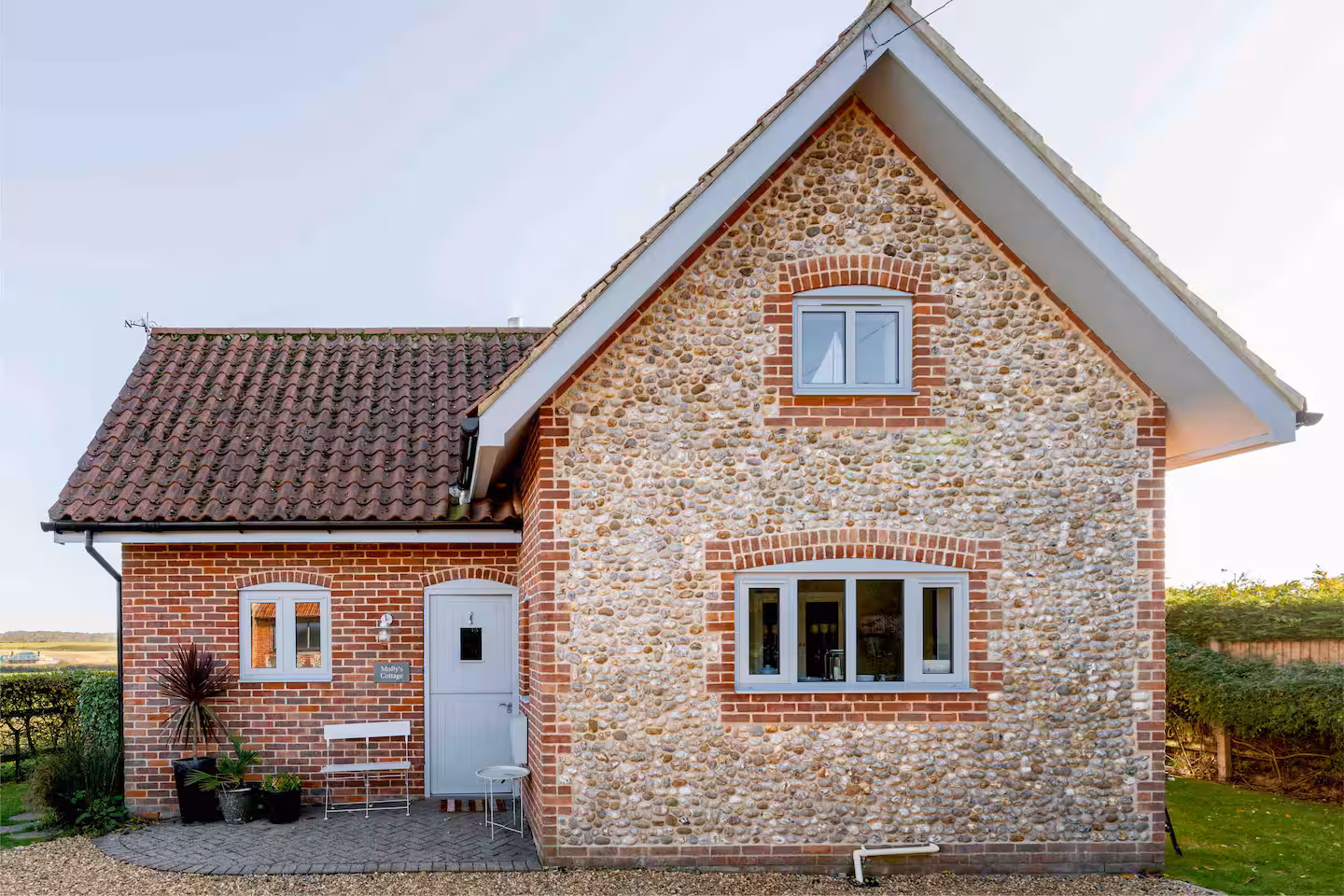 The flint and brick front of Molly’s Cottage with its traditional pantile roof
